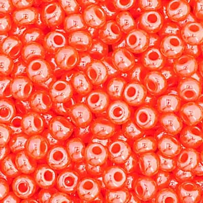 Close-up of Preciosa 11/0 Czech glass seed beads in opaque dark orange with a luster finish