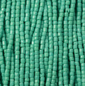Close-up of strung Preciosa 9/0 three-cut glass seed beads in opaque green turquoise