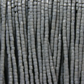 Close-up of strung Preciosa 9/0 three-cut glass seed beads in opaque grey