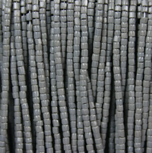 Close-up of strung Preciosa 9/0 three-cut glass seed beads in opaque grey