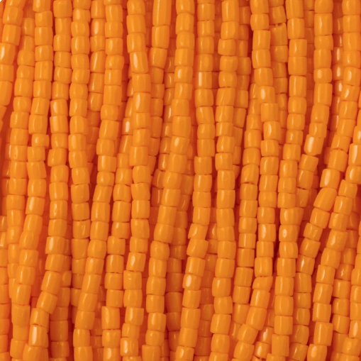 Close-up of strung Preciosa 9/0 three-cut glass seed beads in opaque light orange