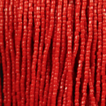 Close-up of strung Preciosa 9/0 three-cut glass seed beads in opaque light red
