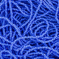 Close-up of strung Preciosa 13/0 true cut charlotte beads in opaque light blue
