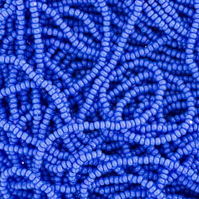 Close-up of strung Preciosa 13/0 true cut charlotte beads in opaque light blue