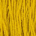 Close-up of strung Preciosa 9/0 three-cut glass seed beads in opaque light yellow