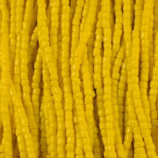 Close-up of strung Preciosa 9/0 three-cut glass seed beads in opaque light yellow