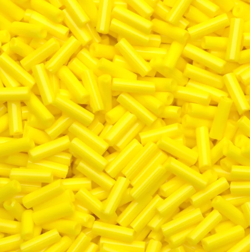Close-up of loose 6mm Preciosa Czech glass bugle beads in opaque light yellow