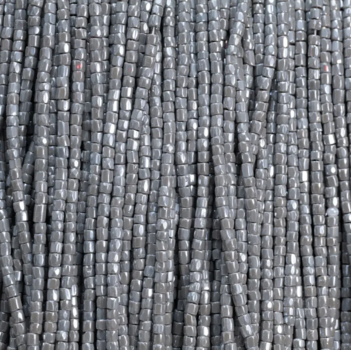 Close-up of strung Preciosa 9/0 three-cut glass seed beads in opaque grey with a luster finish