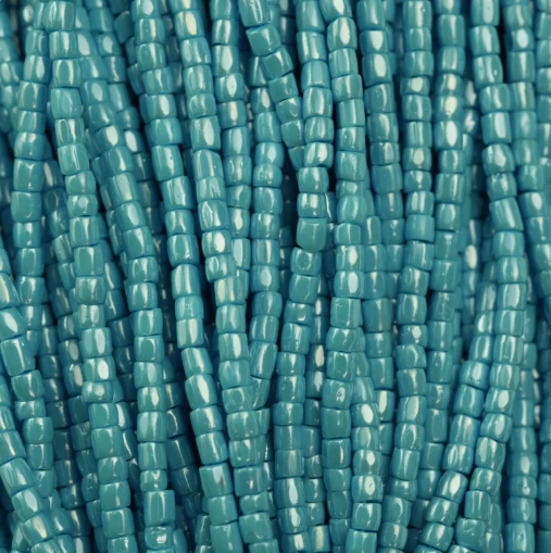 Close-up of strung Preciosa 9/0 three-cut glass seed beads in opaque light blue turquoise with a luster finish