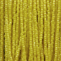 Close-up of strung Preciosa 9/0 three-cut glass seed beads in opaque light yellow with a luster finish