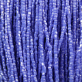 Close-up of strung Preciosa 9/0 three-cut glass seed beads in opaque medium blue with a luster finish