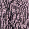 Close-up of strung Preciosa 13/0 true cut charlotte beads in opaque mauve