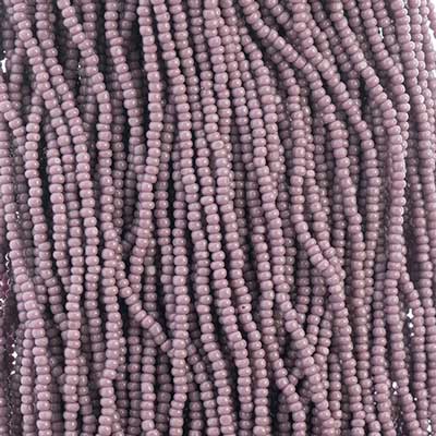 Close-up of strung Preciosa 13/0 true cut charlotte beads in opaque mauve