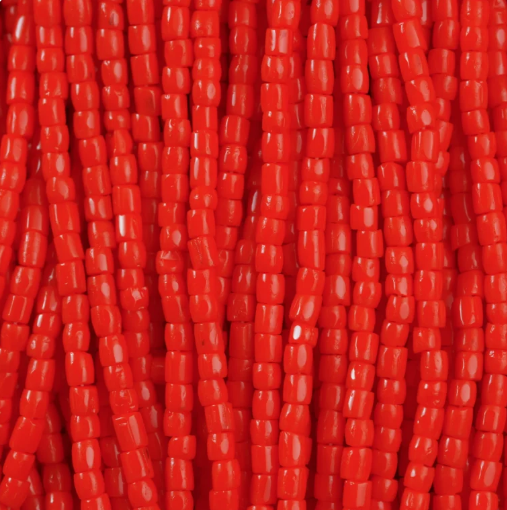 Close-up of strung Preciosa 9/0 three-cut glass seed beads in opaque orange