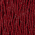 Close-up of strung Preciosa 9/0 three-cut glass seed beads in opaque red