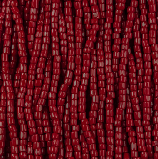 Close-up of strung Preciosa 9/0 three-cut glass seed beads in opaque red
