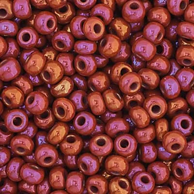Close-up of Preciosa 11/0 Czech glass seed beads in opaque ruby with an AB rainbow finish