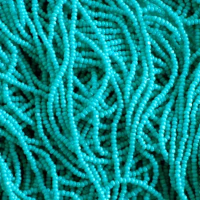 Close-up of strung Preciosa 13/0 true cut charlotte beads in opaque turquoise