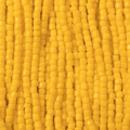 Close-up of strung Preciosa 9/0 three-cut glass seed beads in opaque yellow