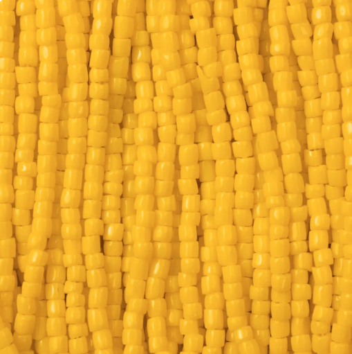 Close-up of strung Preciosa 9/0 three-cut glass seed beads in opaque yellow