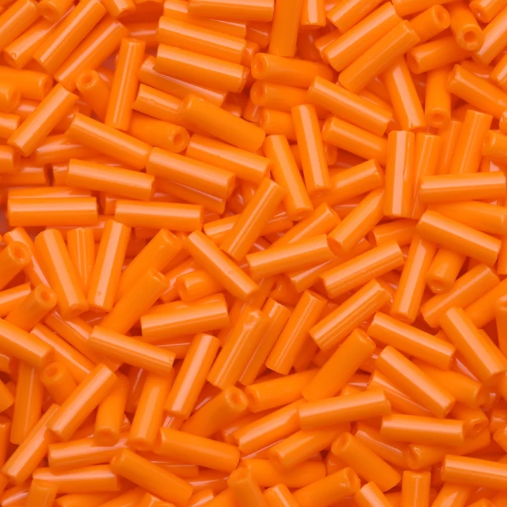 Close-up of loose 6mm Preciosa Czech glass bugle beads in opaque medium orange