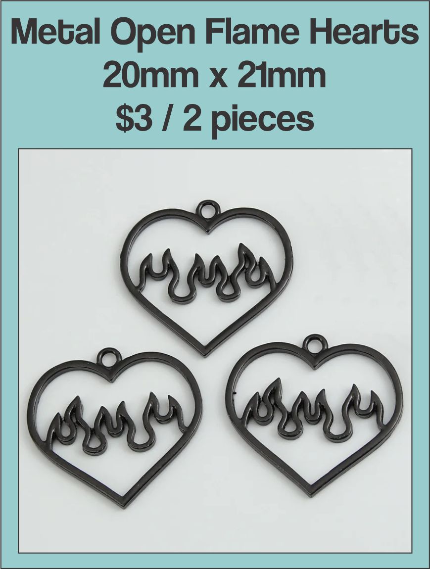 Three black 20 x 21mm open heart charms with flame cut-outs on a labelled product card