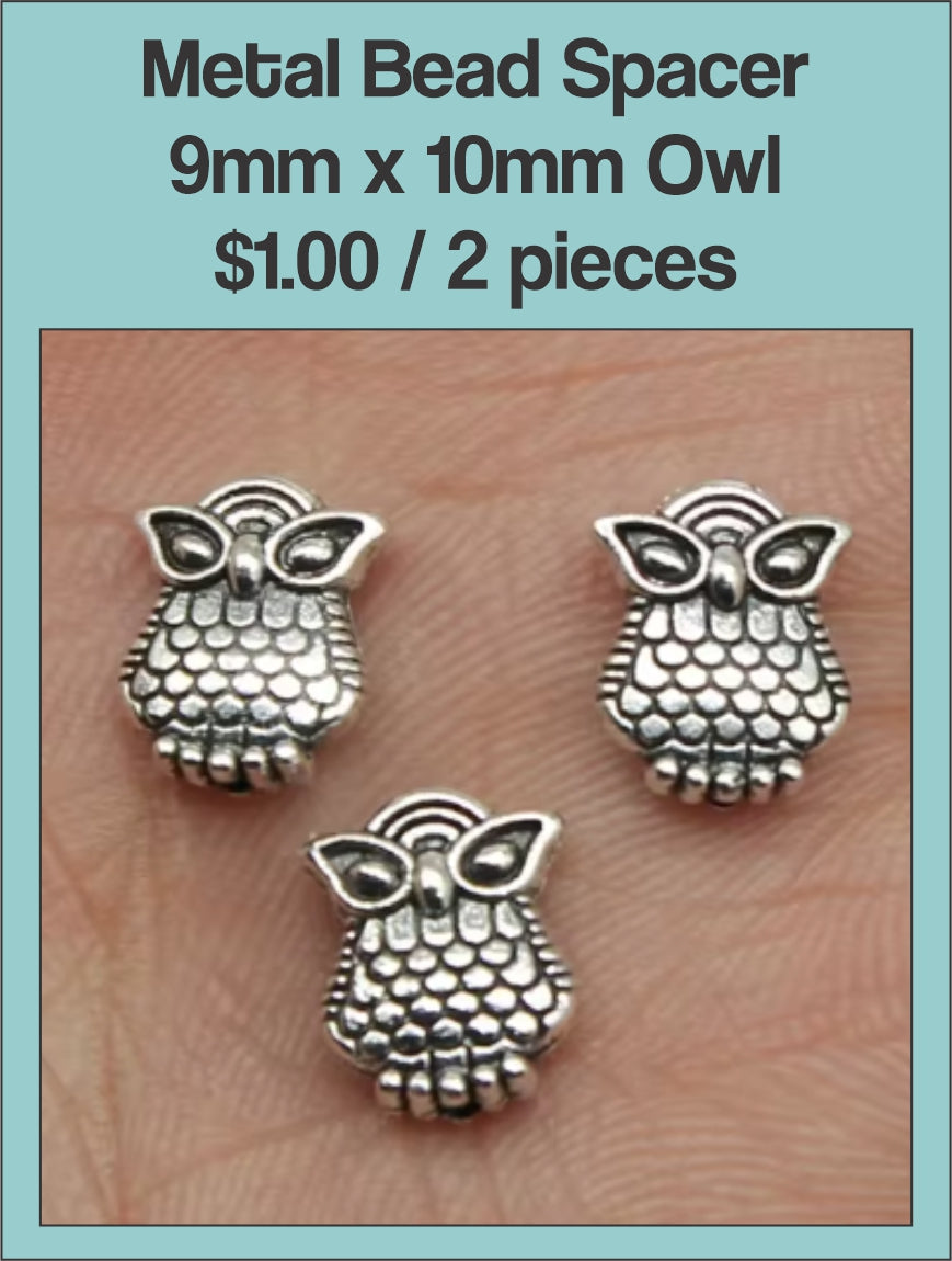 Three silver-tone 9 x 10mm owl spacer beads on a labelled product card