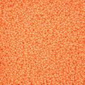 Close-up of Preciosa 11/0 Czech glass seed beads in pearl orange chalk terra intensive with a luster finish