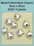 Silver-tone 11 x 13mm puffed heart charms with loops, five shown on a white background