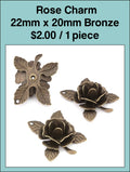 Bronze-tone 22 x 20mm rose charms shown from the front and back