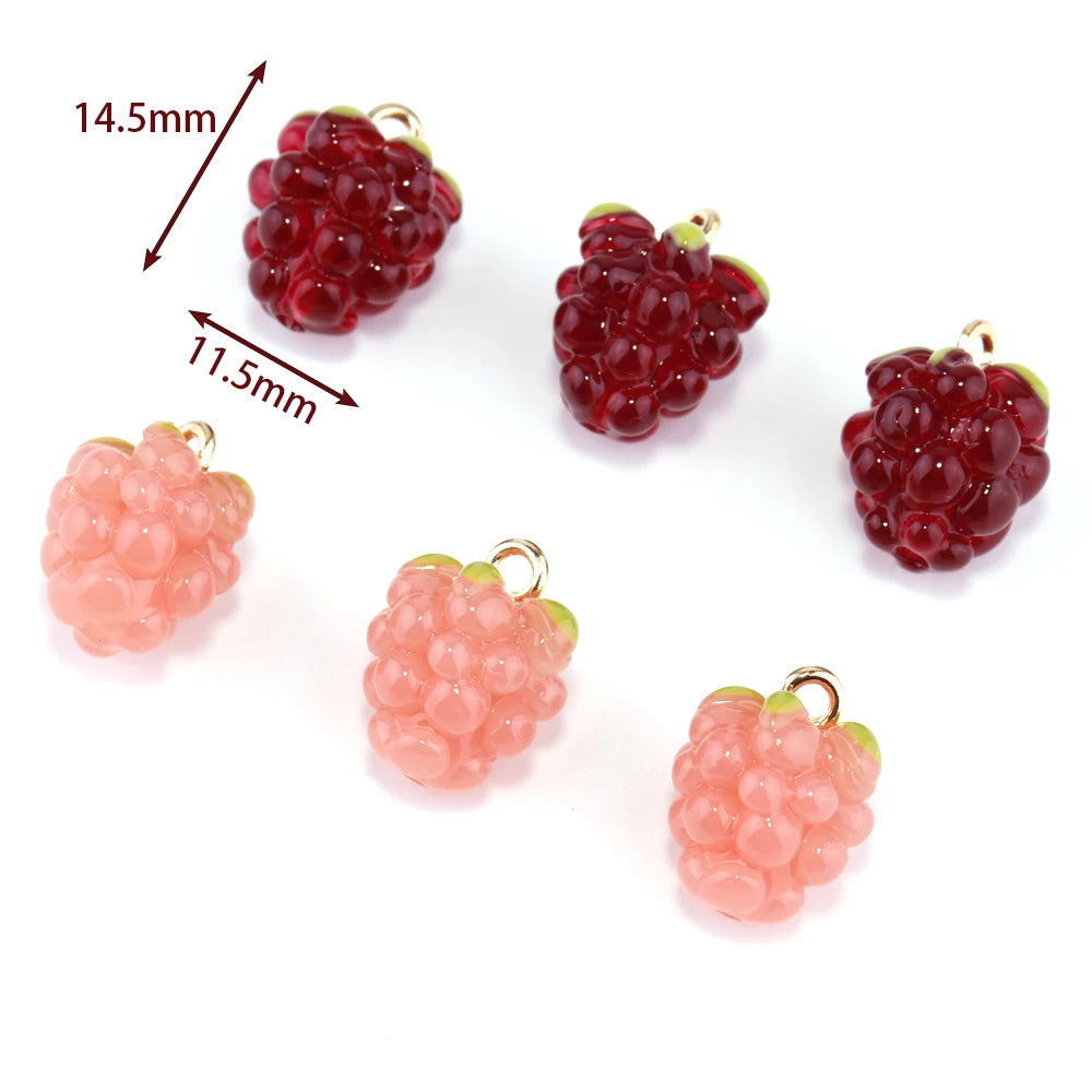 Resin berry charms in red and pink with arrows marking the 14.5mm by 11.5mm size
