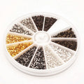 Round divided case of mixed metal crimp tubes in silver, gold, copper and gunmetal tones