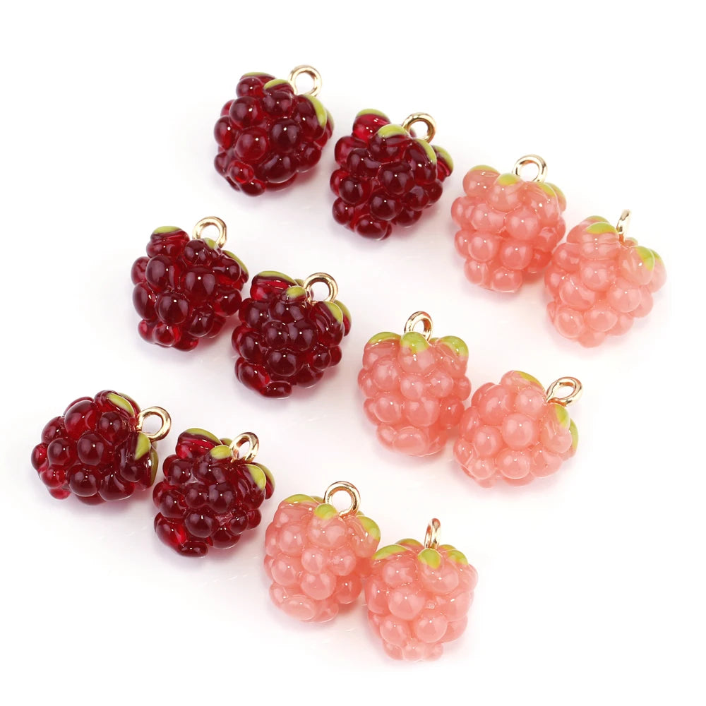 Resin raspberry-style berry charms in dark red and pink, each with a small green cap and loop