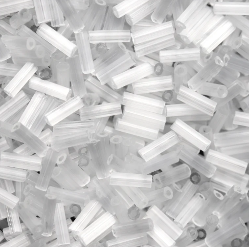 Close-up of loose 6mm Preciosa Czech glass bugle beads in satin white