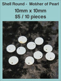 Round mother of pearl disc pendants, 10 x 10mm, with a drill hole, on a dark background