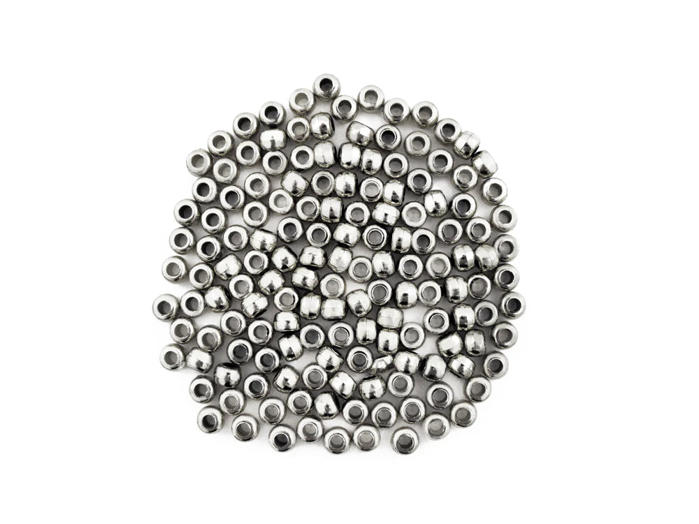 Pile of 6 x 9mm plastic pony beads in metallic silver on a white background