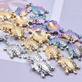 Pile of 25 x 14mm turtle charms in gold, silver and rainbow finishes