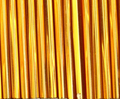 Rows of 30mm Preciosa Czech glass bugle beads in silver-lined brown