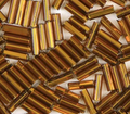 Close-up of loose 6mm Preciosa Czech glass bugle beads in silver-lined brown