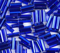 Close-up of loose 6mm Preciosa Czech glass bugle beads in silver-lined capri blue
