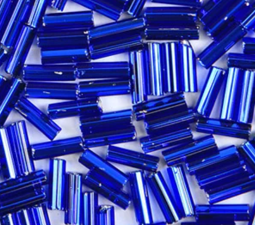 Close-up of loose 6mm Preciosa Czech glass bugle beads in silver-lined capri blue