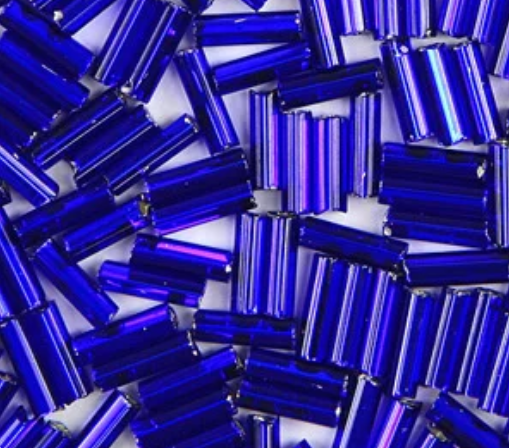 Close-up of loose 6mm Preciosa Czech glass bugle beads in silver-lined cobalt