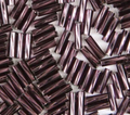 Close-up of loose twisted 6mm Preciosa Czech glass bugle beads in silver-lined dark amethyst