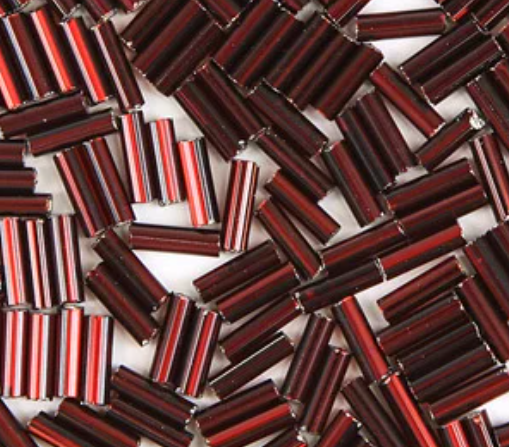 Close-up of loose 6mm Preciosa Czech glass bugle beads in silver-lined dark red
