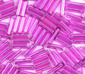 Close-up of loose 6mm Preciosa Czech glass bugle beads in dyed silver-lined purple