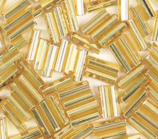 Close-up of loose 6mm Preciosa Czech glass bugle beads in silver-lined gold