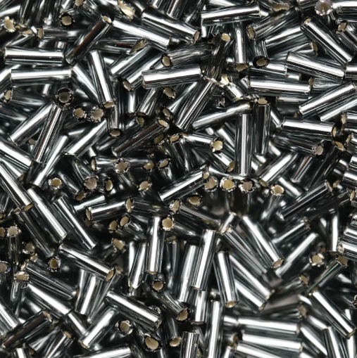 Close-up of loose 6mm Preciosa Czech glass bugle beads in silver-lined grey