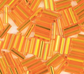 Close-up of loose 6mm Preciosa Czech glass bugle beads in silver-lined light orange