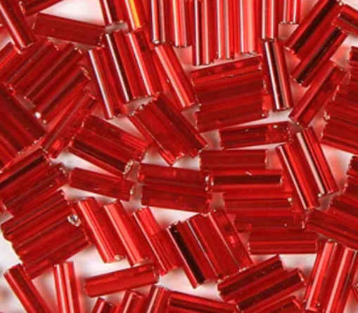Close-up of loose 6mm Preciosa Czech glass bugle beads in silver-lined light red