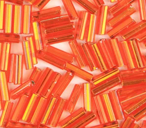 Close-up of loose 6mm Preciosa Czech glass bugle beads in silver-lined orange
